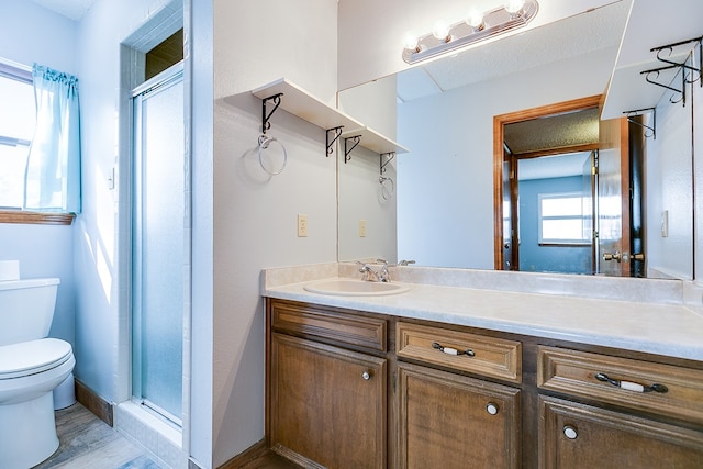 bathroom with vanity, toilet, a shower with shower door, and hardwood / wood-style floors