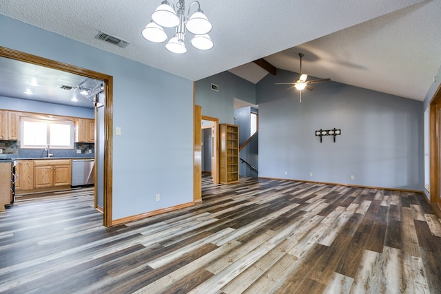 unfurnished living room featuring sink, dark hardwood / wood-style floors, vaulted ceiling, and a textured ceiling