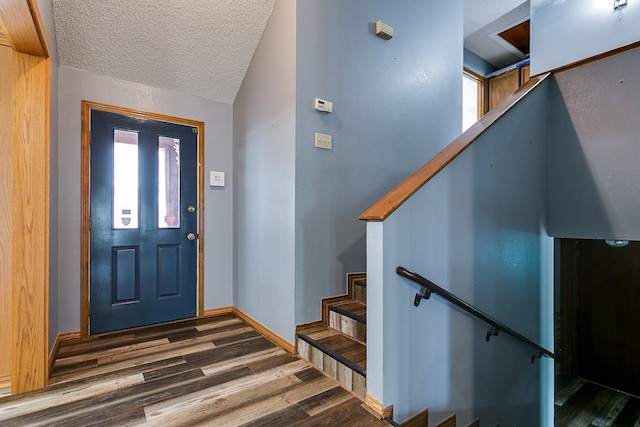 entryway featuring dark hardwood / wood-style floors and a textured ceiling