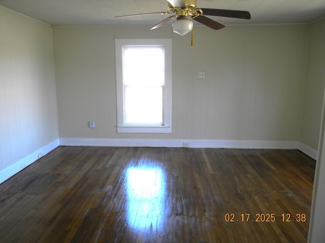 empty room featuring dark hardwood / wood-style flooring and ceiling fan