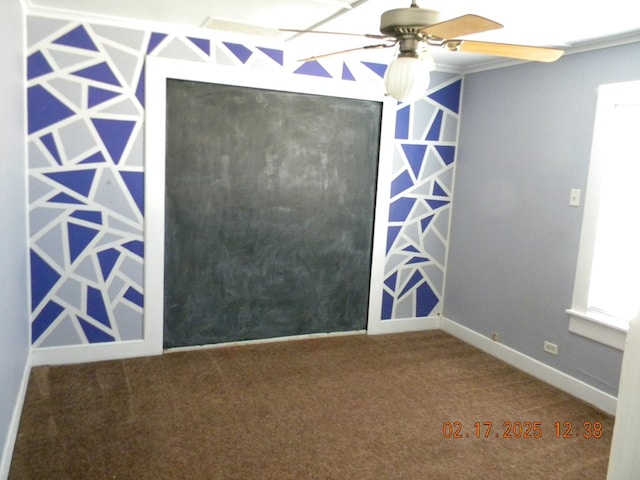 unfurnished room with ceiling fan and carpet flooring