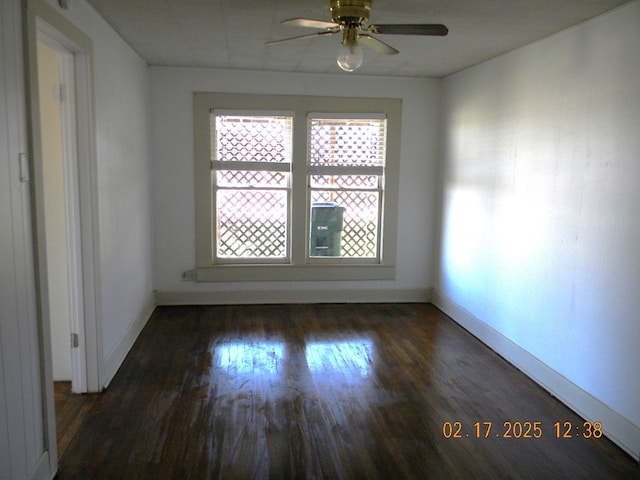 unfurnished room featuring ceiling fan and dark hardwood / wood-style flooring