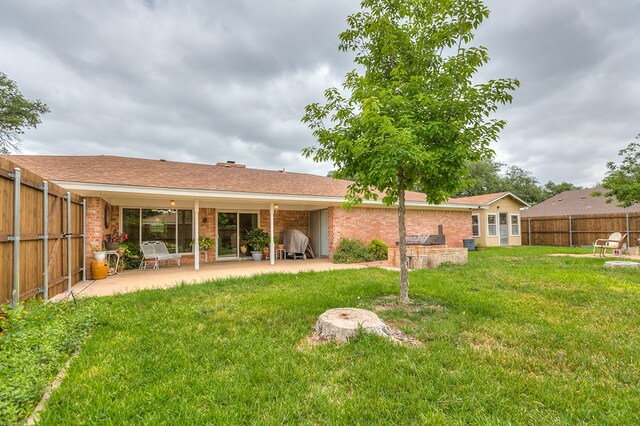 3305 Sierra Ct, San Angelo, TX 76904 - rear view of house with brick siding and a patio area