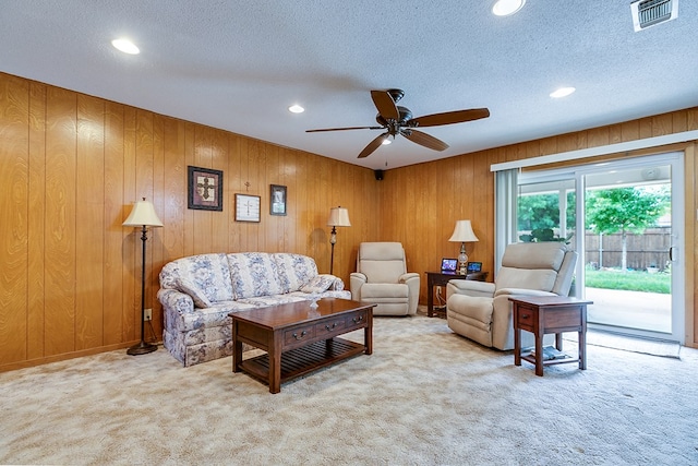 3305 Sierra Ct, San Angelo, TX 76904 - living area with carpet floors, recessed lighting, ceiling fan, wood walls, and a textured ceiling
