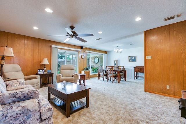 3305 Sierra Ct, San Angelo, TX 76904 - living area with recessed lighting, a textured ceiling, a ceiling fan, light colored carpet, and wood walls