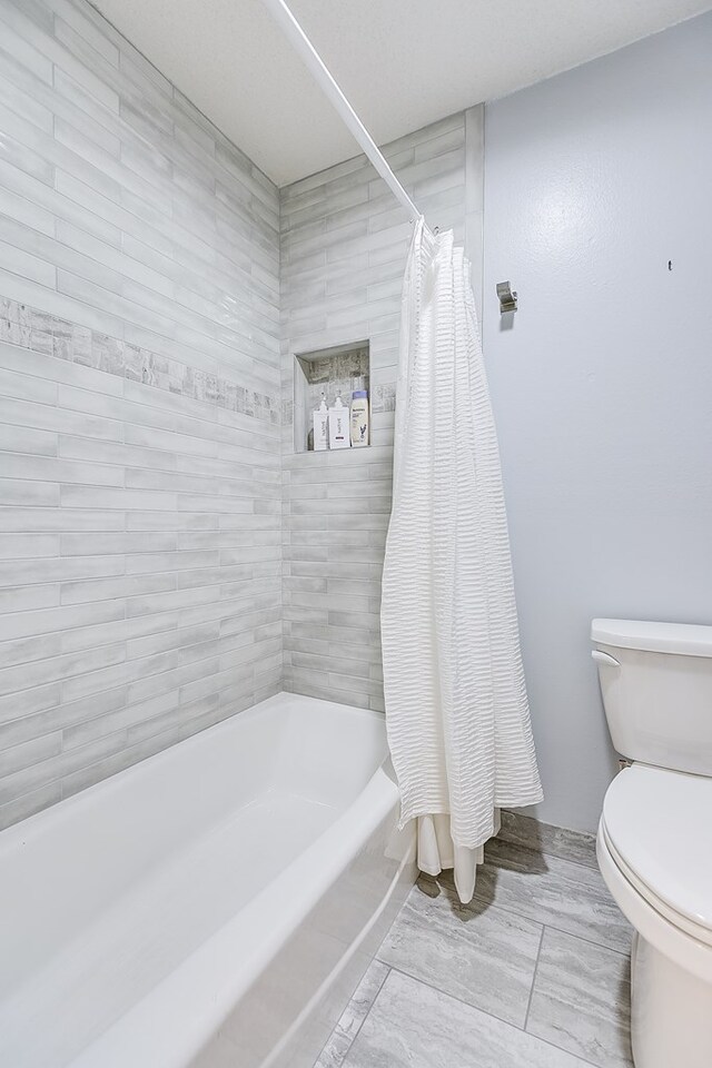 3305 Sierra Ct, San Angelo, TX 76904 - bathroom with toilet and shower / tub combo with curtain