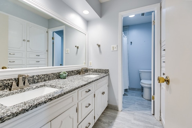 3305 Sierra Ct, San Angelo, TX 76904 - full bath with toilet, baseboards, and double vanity