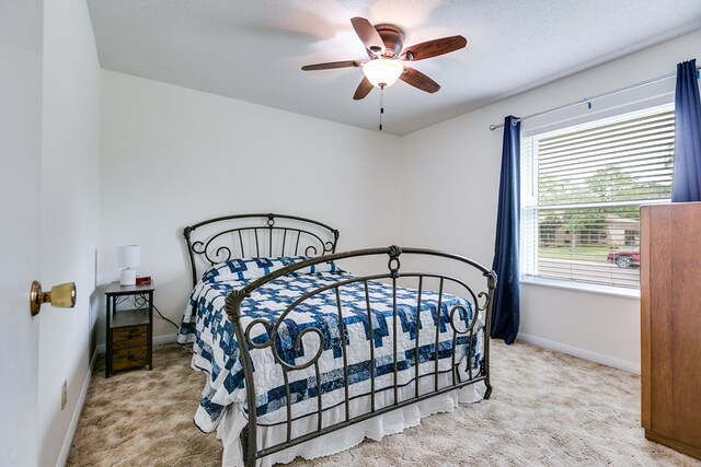 3305 Sierra Ct, San Angelo, TX 76904 - carpeted bedroom with baseboards and a ceiling fan