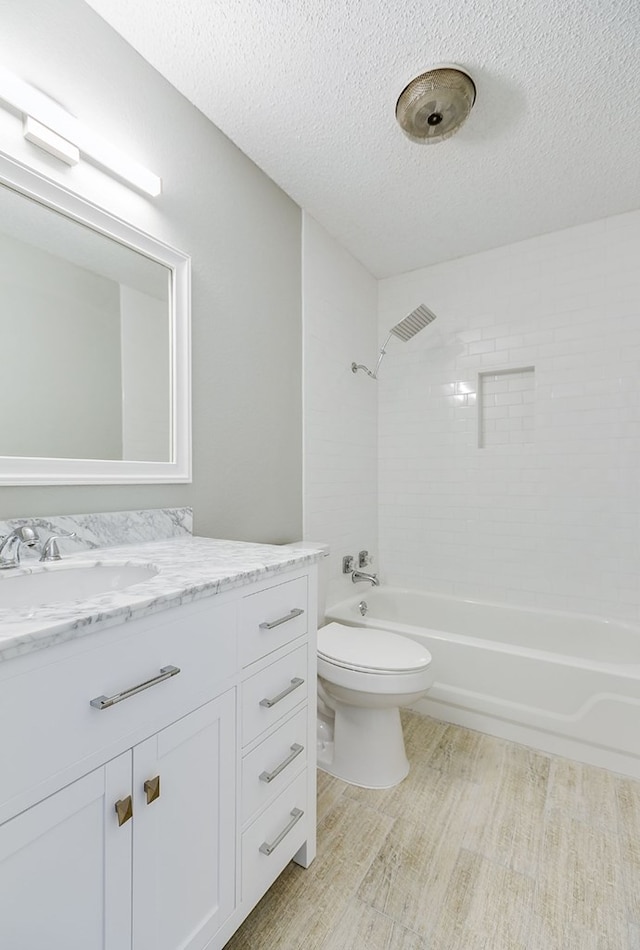 full bath with a textured ceiling, toilet, shower / bathing tub combination, wood finished floors, and vanity