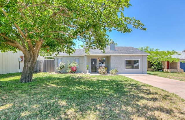 ranch-style house featuring brick siding, a front lawn, and fence
