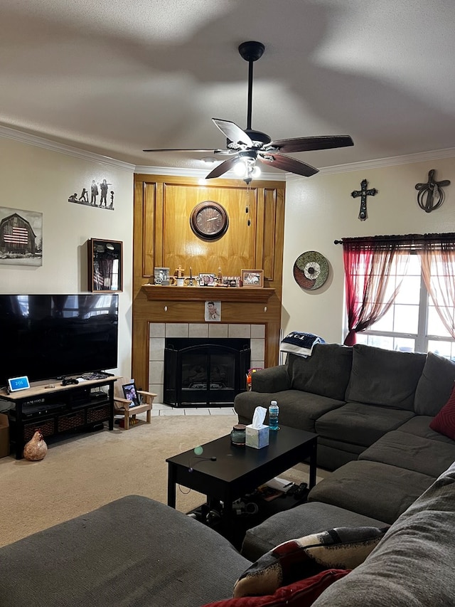 living room with crown molding, carpet floors, ceiling fan, and a fireplace