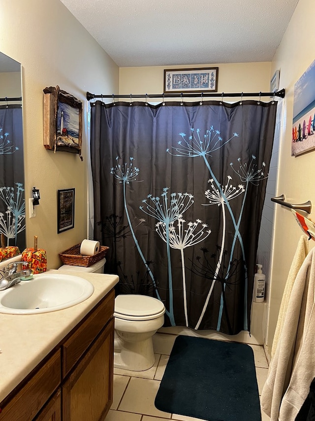 bathroom featuring tile patterned flooring, a shower with shower curtain, vanity, a textured ceiling, and toilet