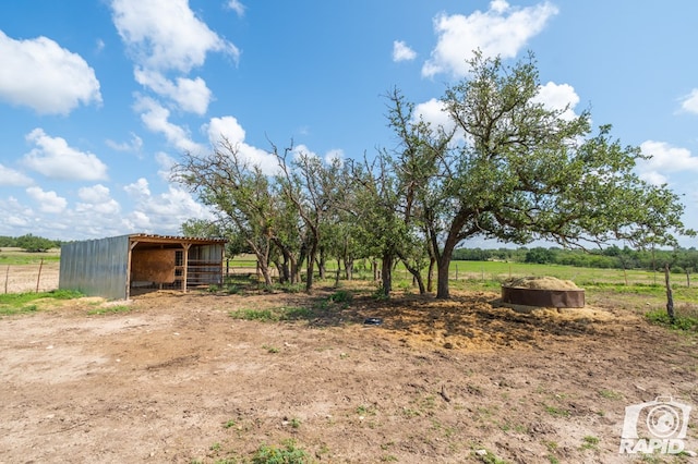 view of yard featuring an outbuilding and a rural view