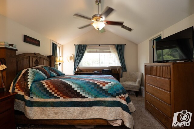 carpeted bedroom with vaulted ceiling and ceiling fan