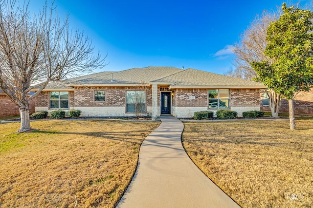 ranch-style home featuring a front yard