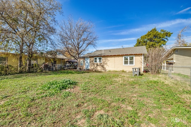 back of property featuring a lawn