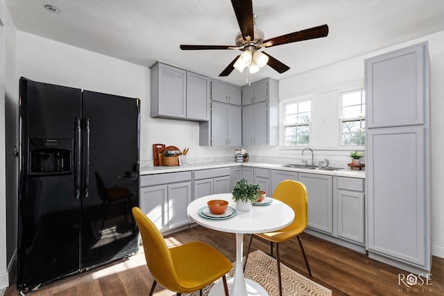 kitchen with dark hardwood / wood-style flooring, sink, black refrigerator with ice dispenser, and gray cabinetry