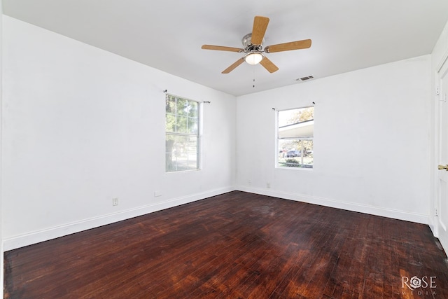 unfurnished room with a wealth of natural light, wood-type flooring, and ceiling fan