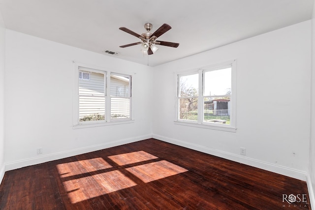 unfurnished room with dark wood-type flooring and ceiling fan