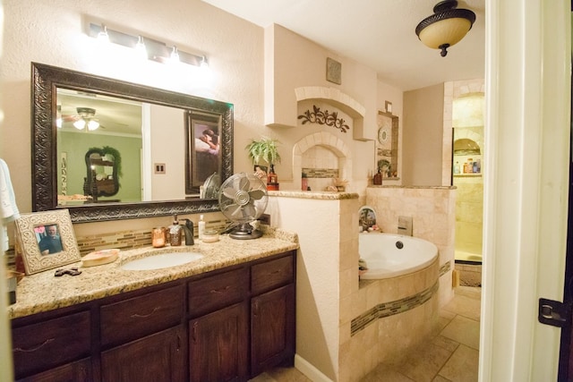 full bathroom featuring tile patterned floors, a bath, and vanity