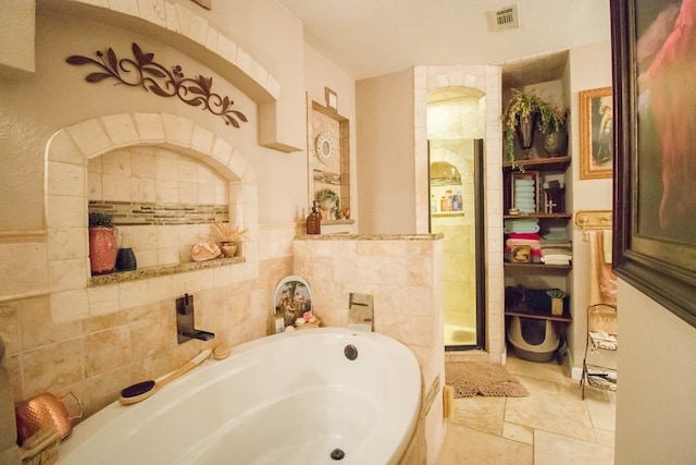 full bathroom with visible vents and a bath