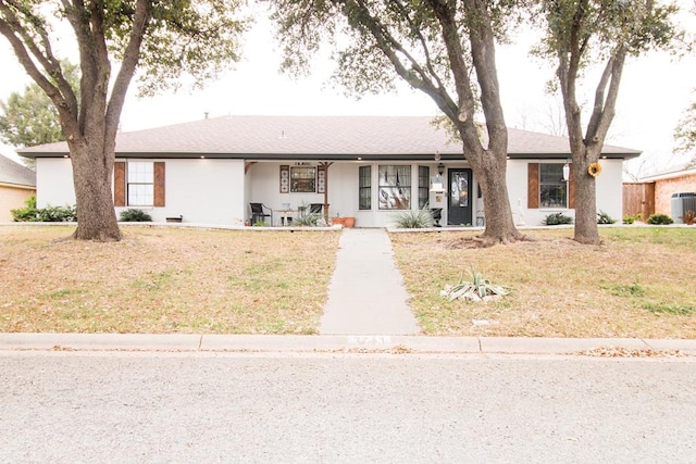 ranch-style home with central AC and a front lawn