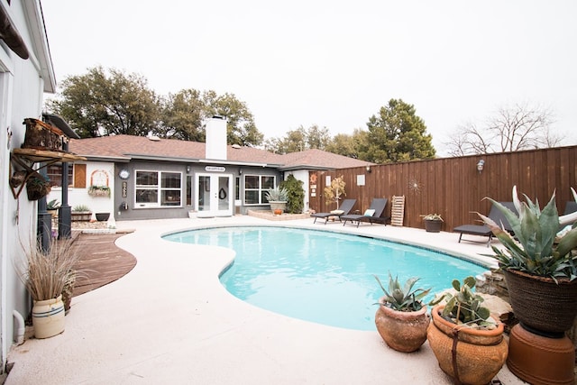 view of swimming pool with a patio area, a fenced backyard, and a fenced in pool