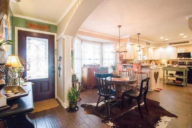 interior space with ornamental molding, arched walkways, plenty of natural light, and wood finished floors