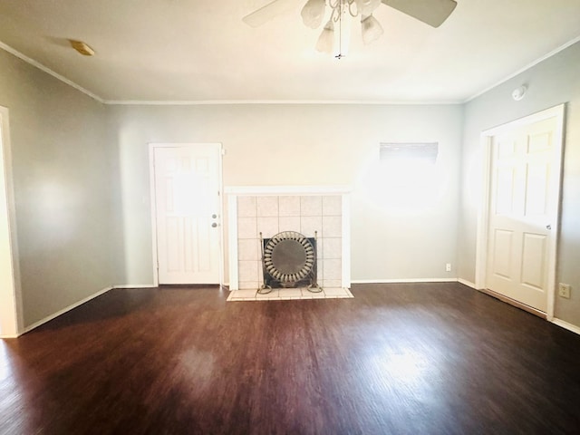 unfurnished living room featuring a tile fireplace, crown molding, baseboards, and wood finished floors