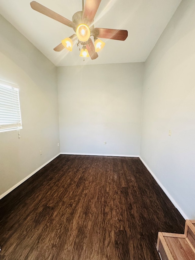 spare room featuring a ceiling fan, baseboards, and wood finished floors