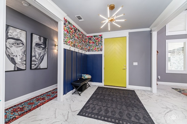 entrance foyer with baseboards, visible vents, marble finish floor, crown molding, and a notable chandelier