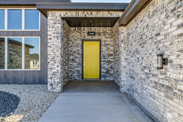 entrance to property with brick siding