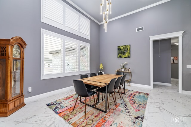 dining room with marble finish floor, visible vents, a towering ceiling, ornamental molding, and baseboards