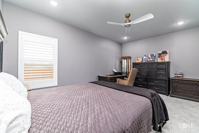 carpeted bedroom with a ceiling fan and recessed lighting