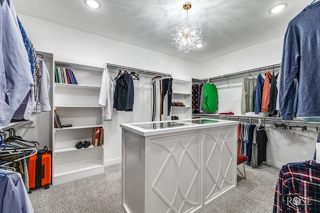 spacious closet with a notable chandelier and light colored carpet