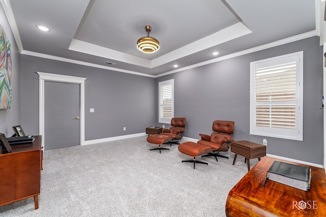 sitting room with carpet, baseboards, a raised ceiling, and ornamental molding