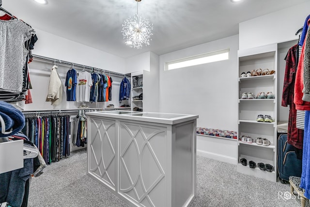 walk in closet featuring carpet floors and a chandelier