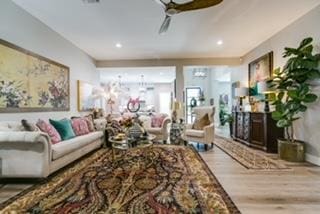 living room featuring ceiling fan and light wood-type flooring