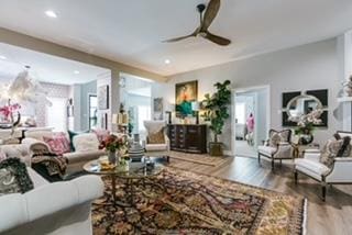 living room with hardwood / wood-style flooring and ceiling fan