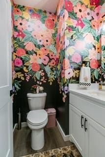 bathroom featuring vanity, toilet, and hardwood / wood-style floors