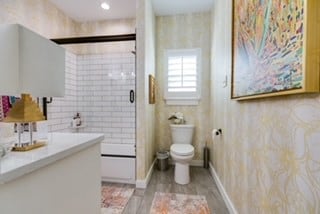 bathroom featuring vanity, toilet, and walk in shower