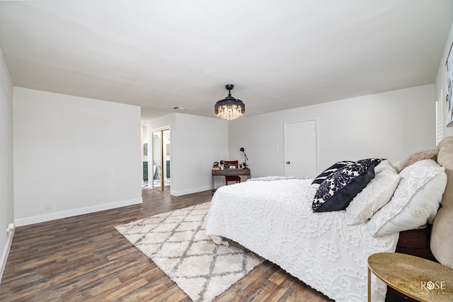 bedroom featuring an inviting chandelier and dark hardwood / wood-style flooring