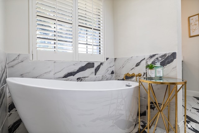 bathroom featuring a bathing tub and tile walls