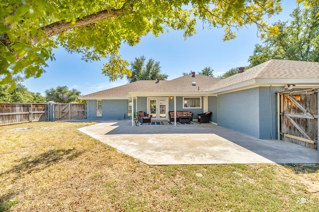 rear view of house with french doors, a yard, and a patio