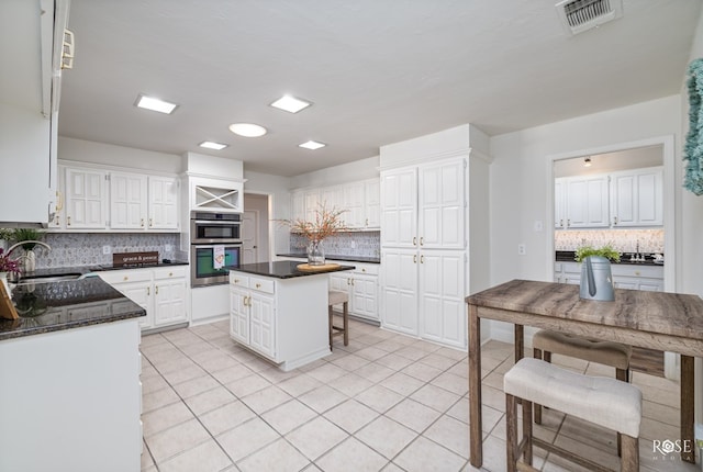 kitchen with white cabinetry and a kitchen island