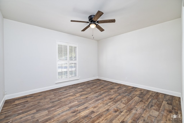 empty room with ceiling fan and dark hardwood / wood-style flooring