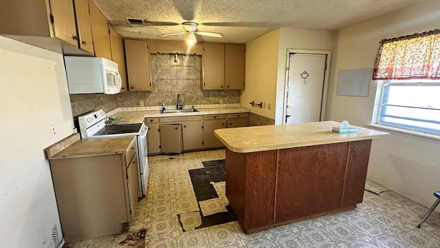 kitchen with visible vents, light floors, light countertops, white appliances, and a sink