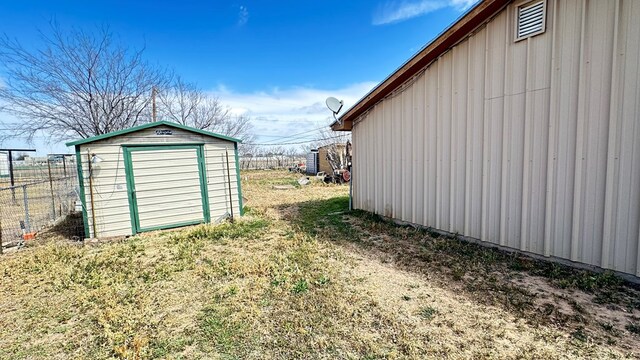 view of shed featuring fence