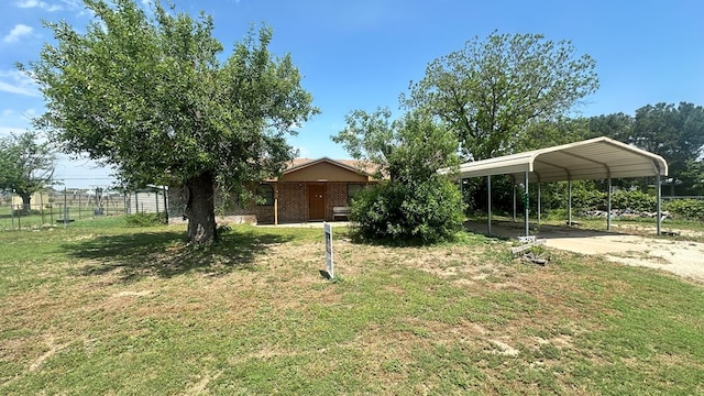 7490 Canna St, San Angelo, TX 76901 - view of yard featuring fence, a detached carport, and driveway