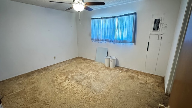 empty room with a textured ceiling and ceiling fan